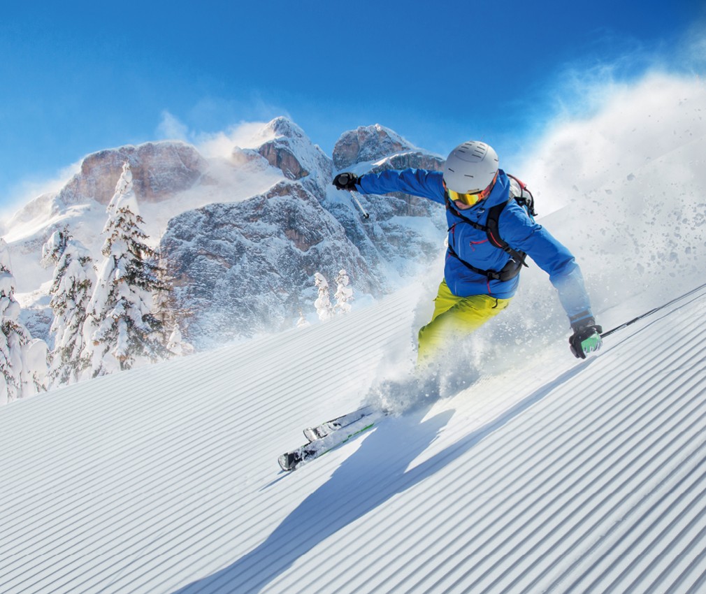 The picture shows a skier and the Dolomites of Val Gardena in South Tyrol in the background